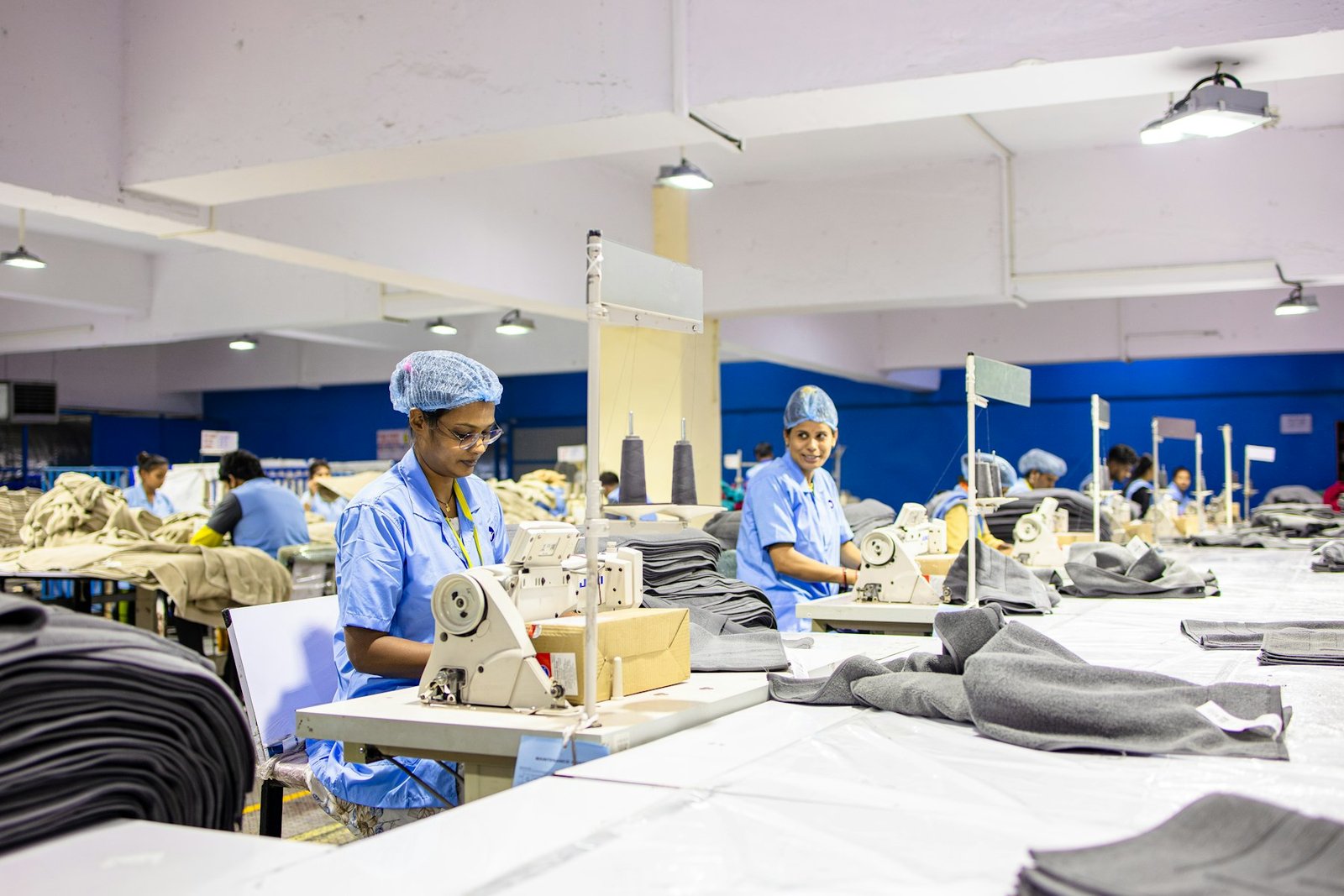 Workers sewing garments on the A3 Styles factory floor